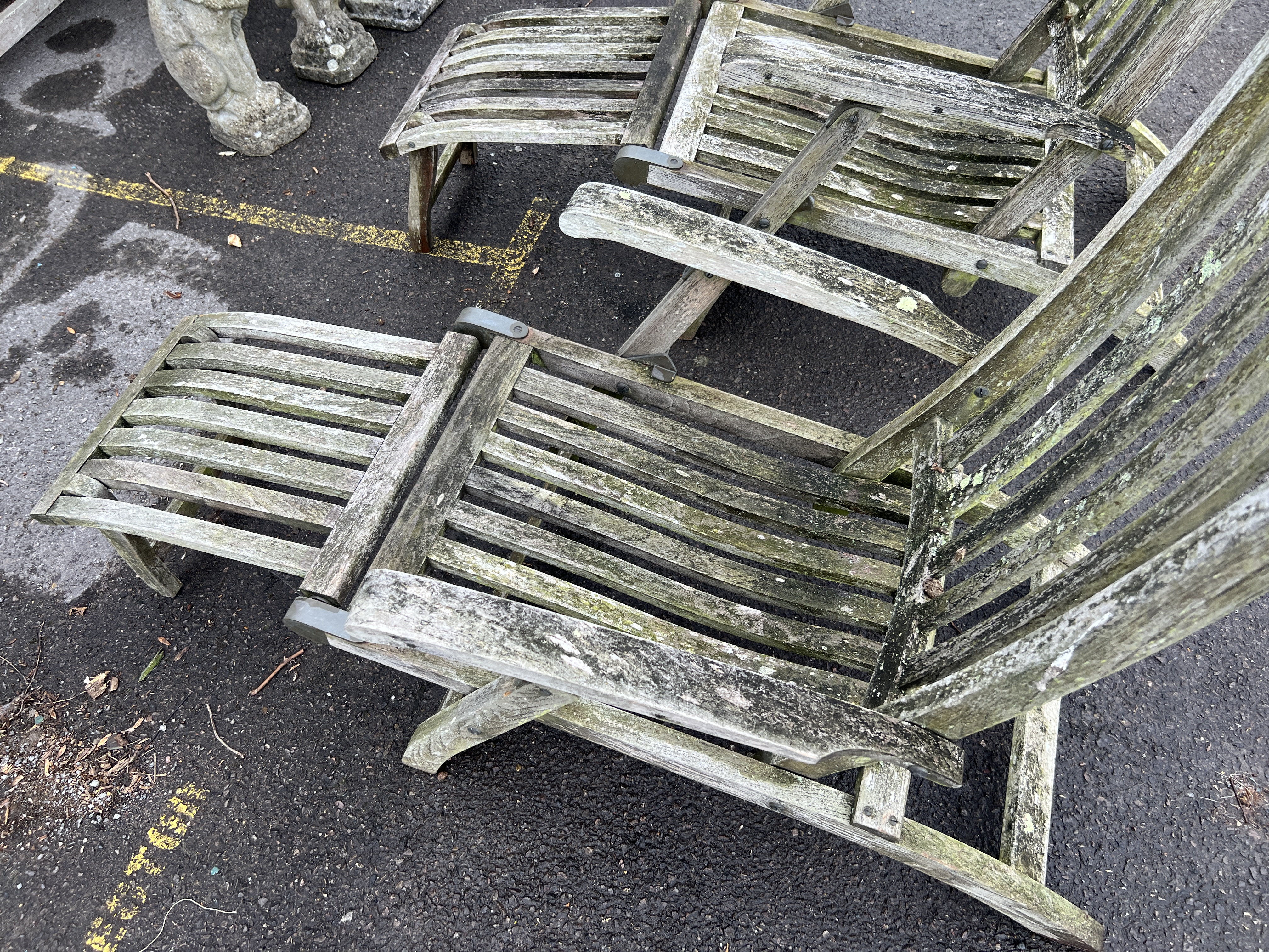 A pair of Barlow Tyrie weathered teak garden steamer chairs, width 60cm, height 96cm